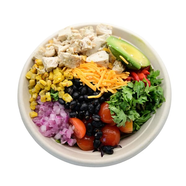Fresh Green salad with chicken, corn, black beans, avocado, cheese, tomatoes, and red onion.